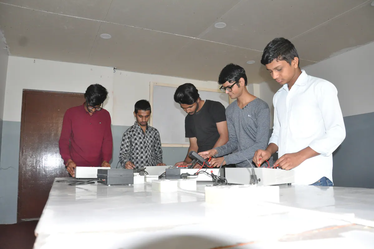 Electronics engineering students working together on a project