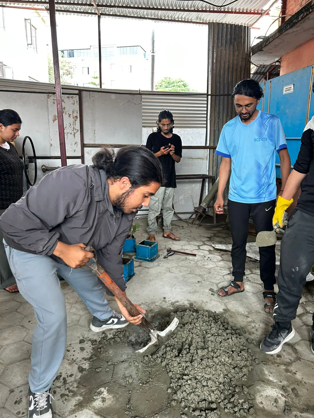 Engineering students collaborating closely during practical work