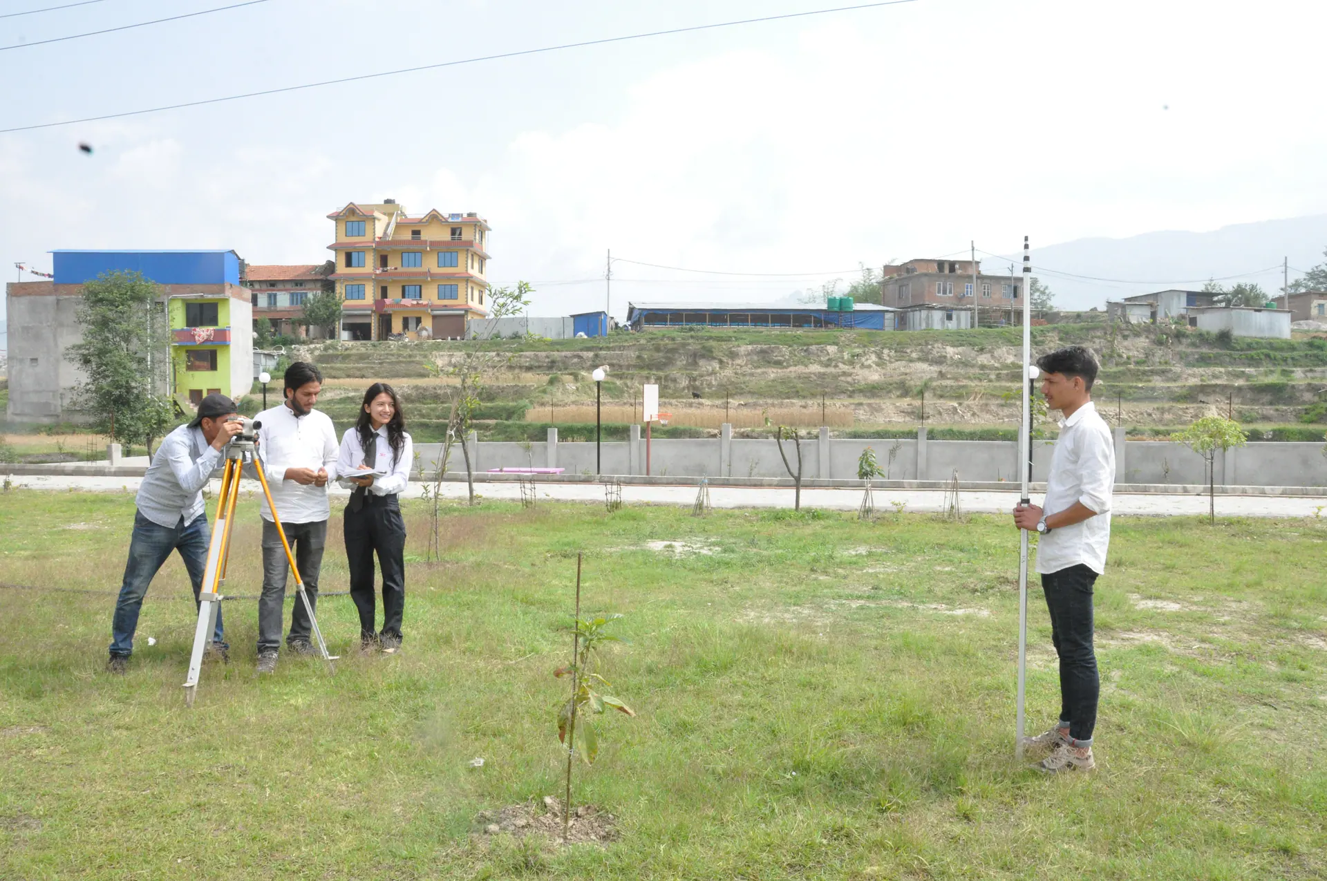 Civil engineering students carrying out survey practice on the campus grounds