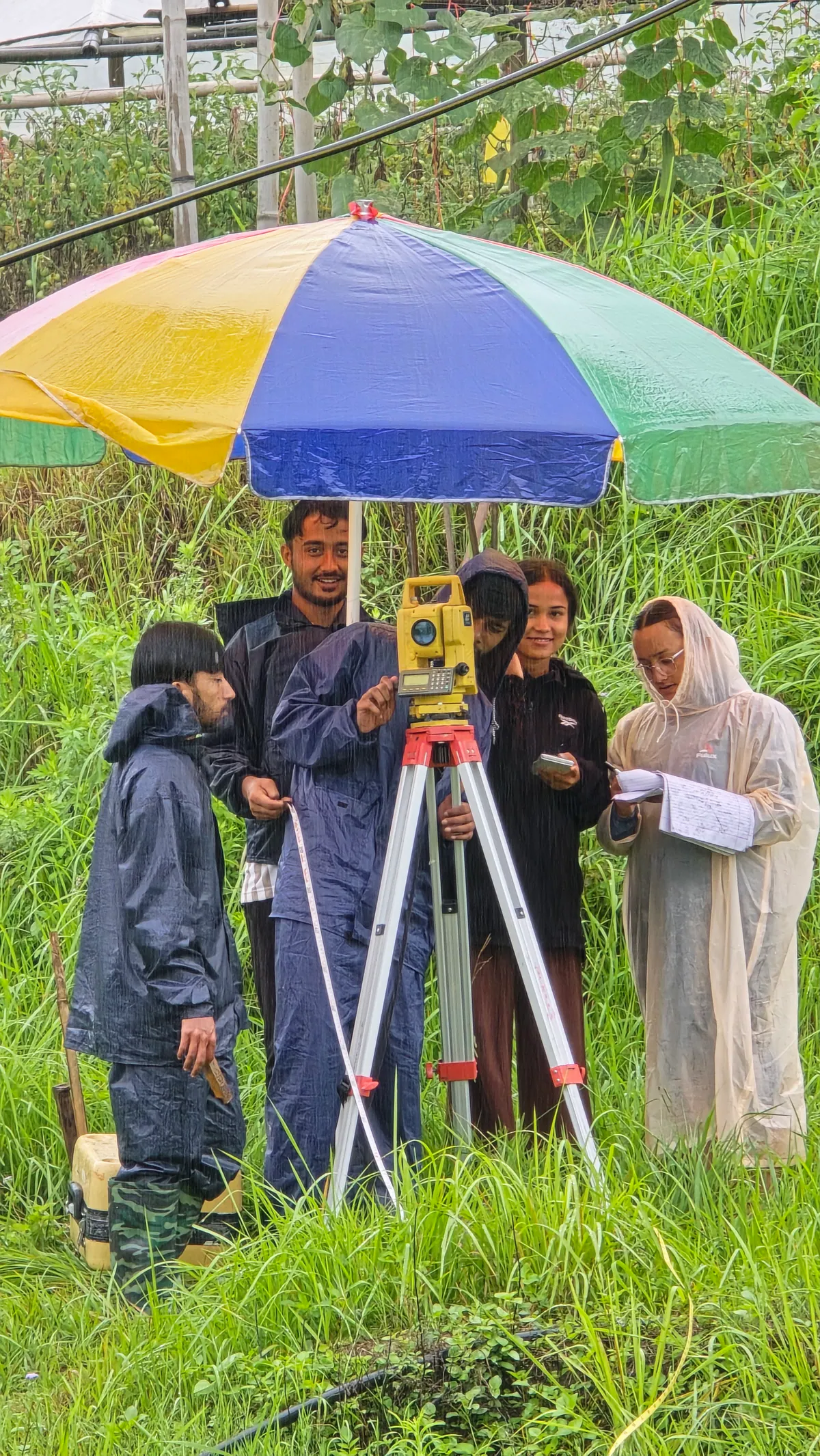 Students working together with a total station during survey camp