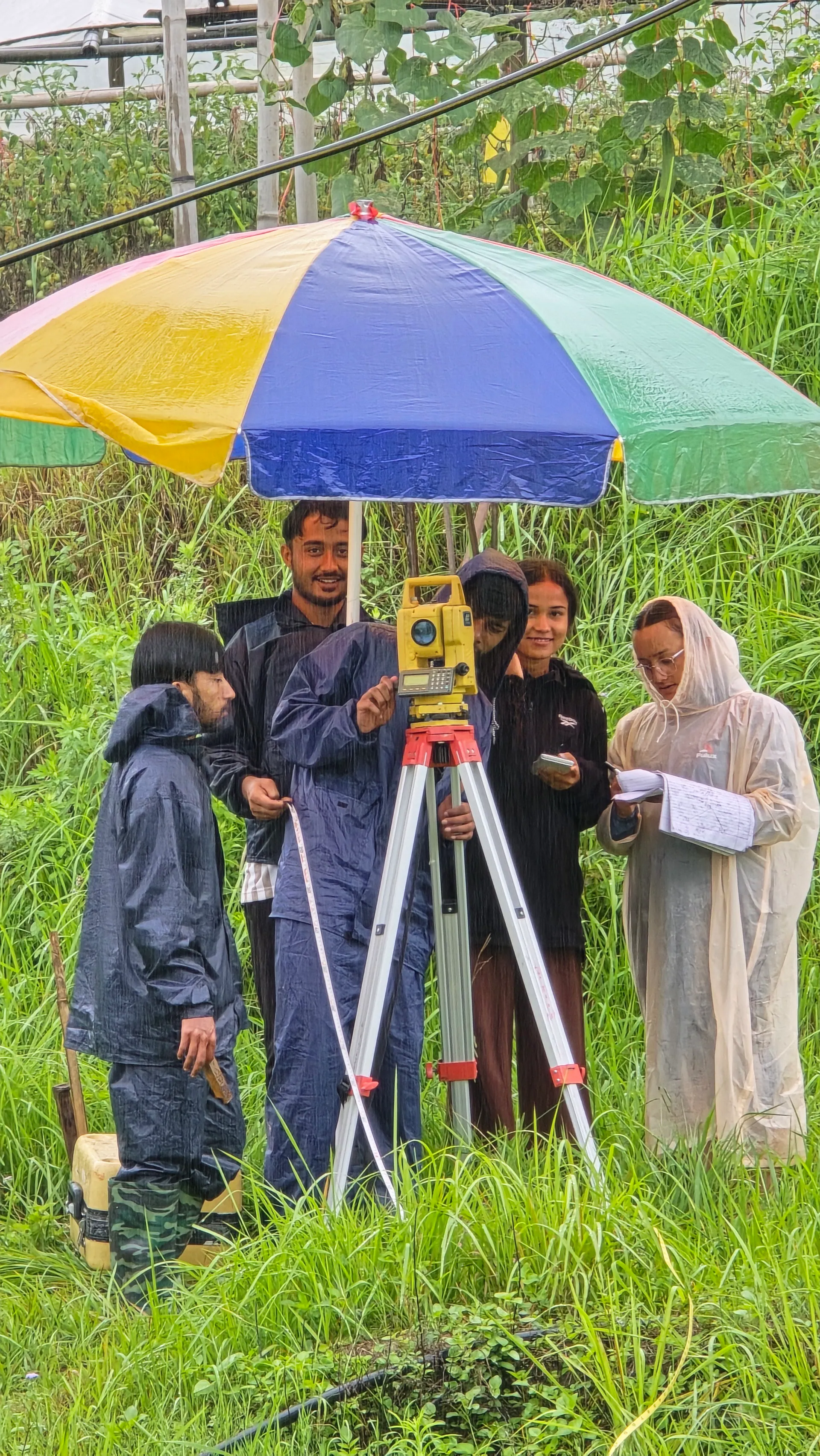 Engineering fieldwork survey team operating total station instrument